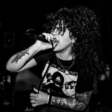 Singer Jerkova of Punitive Damage singing with the crowd at a live show at The Midnight Hour in San Fernando Valley.